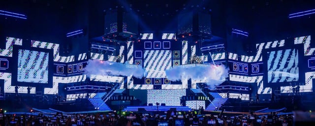 Escenario con luces y pantallas encendidas en azul durante el concierto del 50 aniversario de Grupo 5 en el Estadio San Marcos.